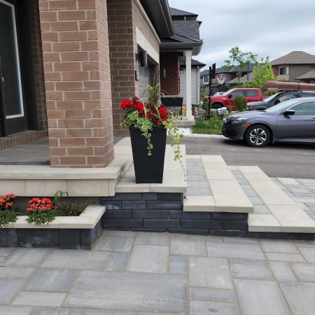 Front entrance with interlock steps and a seamless walkway design for a grand entryway.