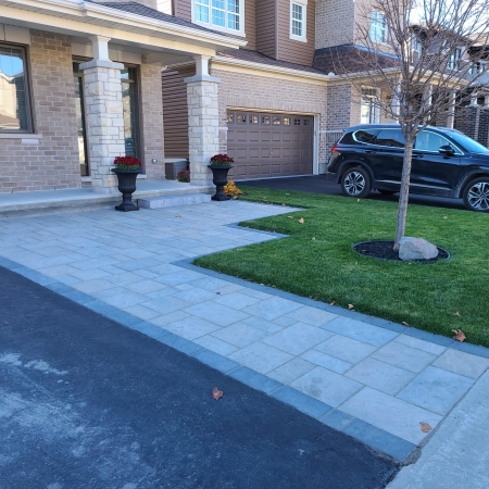New front entrance walkway with premium stone pavers for a polished and welcoming look.
