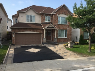 Freshly cleaned and sealed interlock driveway with enhanced color and weather protection.