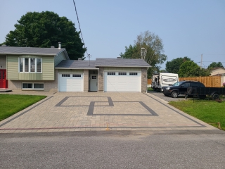 Freshly cleaned and sealed interlock driveway with enhanced color and weather protection.