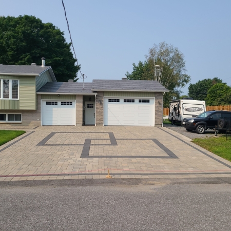 Freshly cleaned and sealed interlock driveway with enhanced color and weather protection.