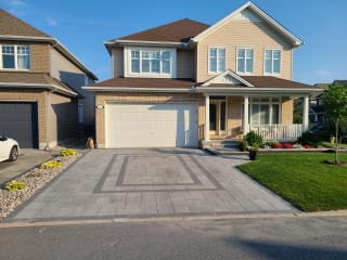 New residential interlock driveway with a smooth, even surface and precise edge detailing.