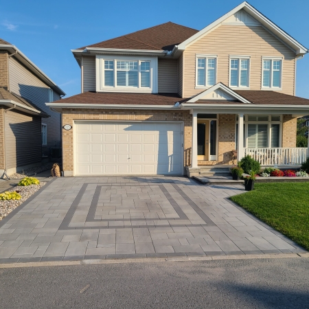 New residential interlock driveway with a smooth, even surface and precise edge detailing.
