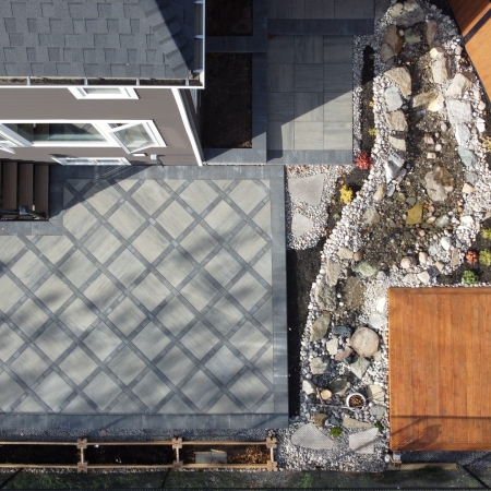 Custom-designed interlocking stone patio with a bold border accent