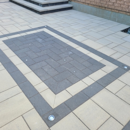 Modern backyard patio with interlock pavers and design and LED lights